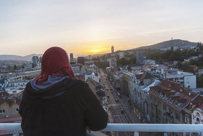 Rear view of woman looking at city buildings