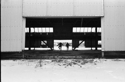 Rear view of people walking on building