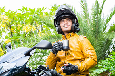 Portrait of smiling young woman riding bicycle