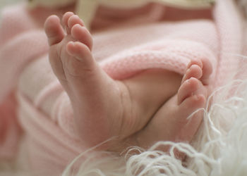 Close-up of baby lying on bed