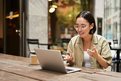 Businesswoman using laptop at table