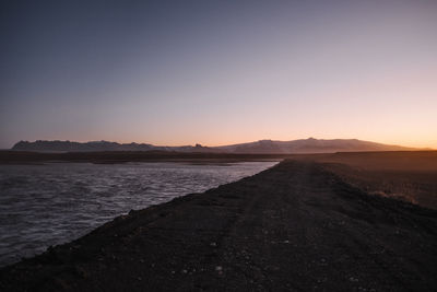 Scenic view of sea against clear sky during sunset