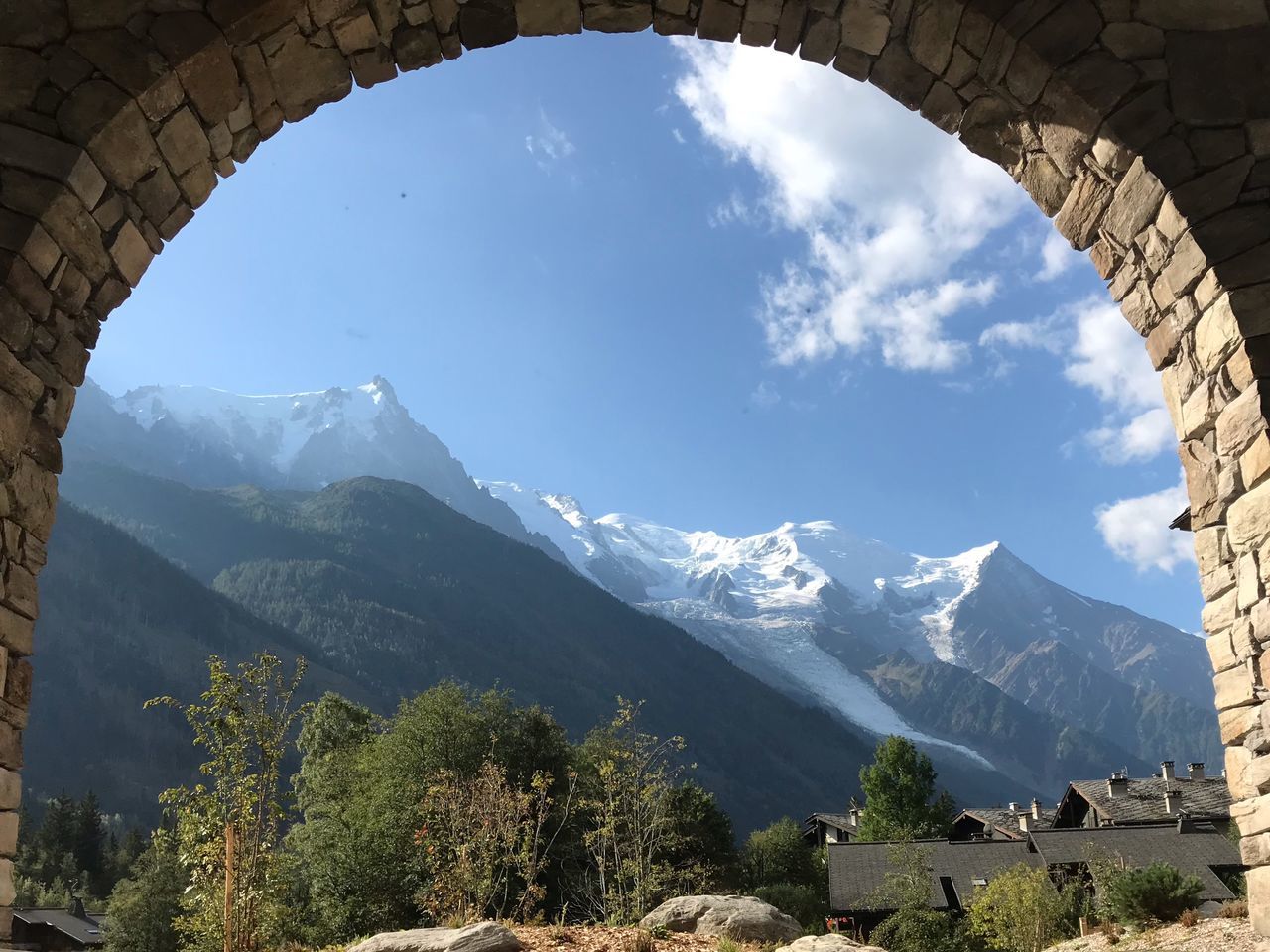 mountain, sky, nature, beauty in nature, mountain range, tree, scenics - nature, day, plant, sunlight, environment, architecture, landscape, cloud - sky, outdoors, tranquility, mountain peak, no people, travel, cold temperature, snowcapped mountain, formation