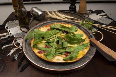 Brazilian pizza with sun-dried tomatoes, arugula and mozzarella. traditional brazilian pizza