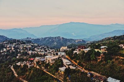 High angle view of townscape and mountains against sky