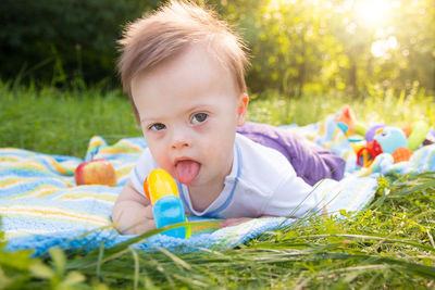 Close-up baby boy on picnic blanket at park