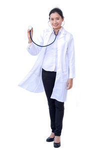 Portrait of a young woman standing against white background