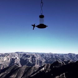 Low angle view of mountains against clear blue sky