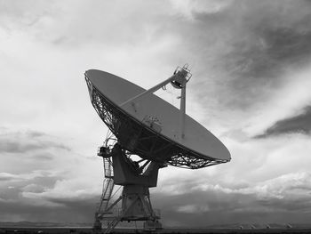 Low angle view of communications tower against sky