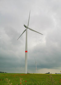 Windmill on field against sky