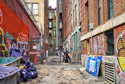 People on street amidst buildings in city