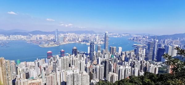 High angle view of city by sea against sky