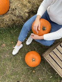 Low section of woman with pumpkin