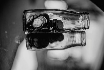 Close-up of hand holding glass bottle