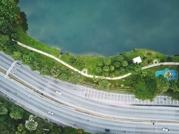 High angle view of road amidst trees against sky