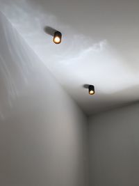 Low angle view of illuminated lights hanging on ceiling