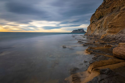 Scenic view of beach against sky during sunset
