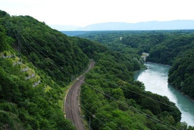 High angle view of road amidst trees against sky