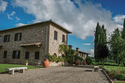 Exterior of houses by building against sky