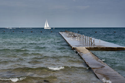 Sailboat on sea against sky