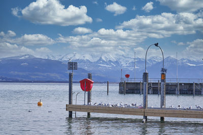 Scenic view of traditional windmill by mountains against sky