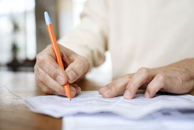 Man writing on bills with pen