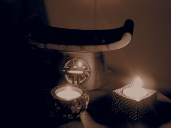 Close-up of illuminated lamp on table