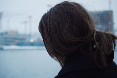 Close-up of woman in city during winter