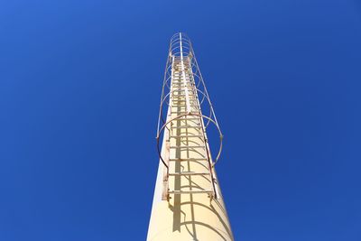 Low angle view of tower against clear blue sky