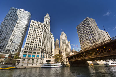 Low angle view of bridge and buildings against sky