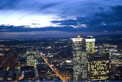 Illuminated cityscape against sky