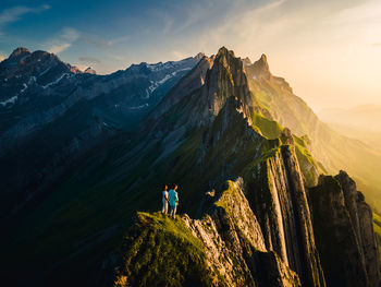 Panoramic view of people on mountain against sky