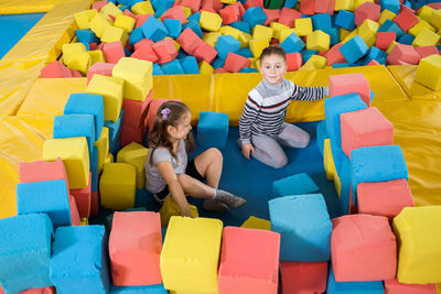 High angle view of people sitting in toys