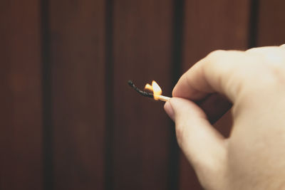 Close-up of hand holding cigarette