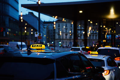 Twilight taxi service in city center during rush hour traffic