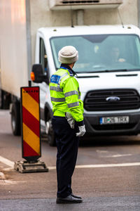 Rear view of man working on street