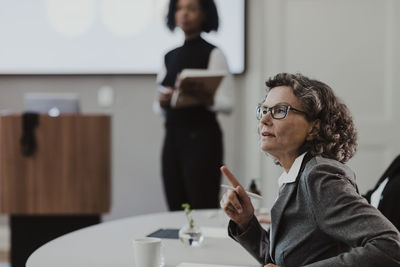 Mature female entrepreneur discussing in training class