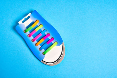 High angle view of colored pencils on blue background