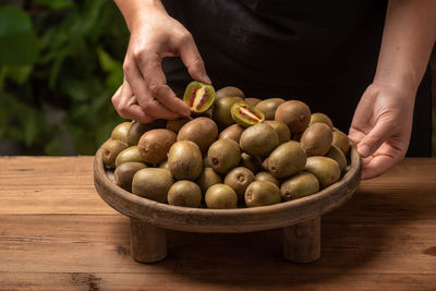 Midsection of man holding fruit