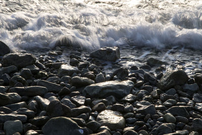 High angle view of waves splashing against shore