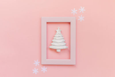 Directly above shot of christmas decoration on pink background
