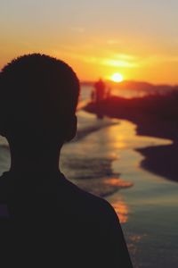 People in water at sunset