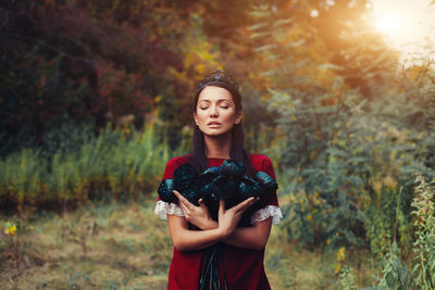 Portrait of a beautiful young woman standing on land