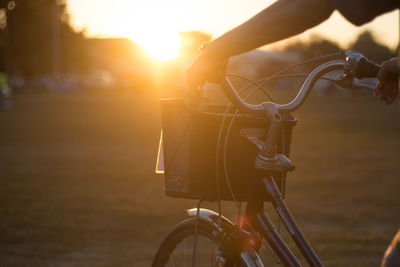 Man riding bicycle on road during sunset