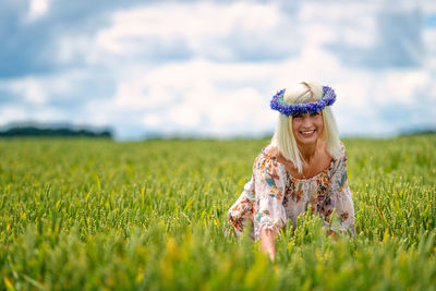 Portrait of a smiling young woman on field