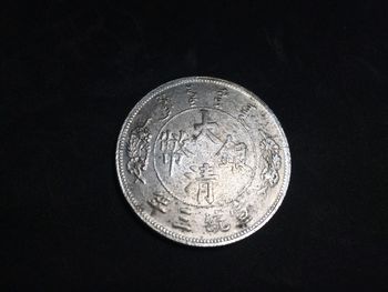 Close-up of coins against black background