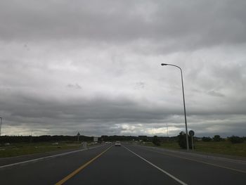 Street against cloudy sky