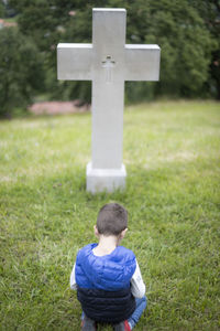 Rear view of boy on field