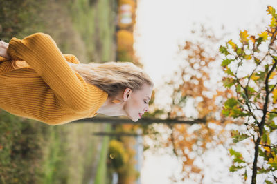 Portrait of teenage girl standing against plants