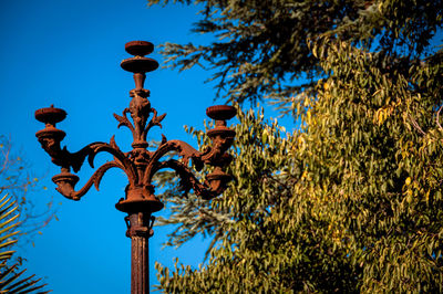 Low angle view of street light against blue sky